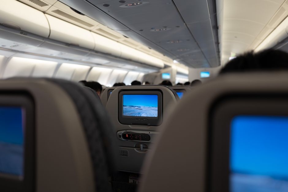 Business Class Flight Upgrade Tricks: traveler enjoying a premium airline cabin seat
