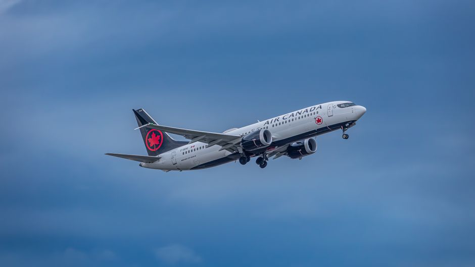 Cheap Flights To Canada From Nigeria: airplane flying over Toronto skyline