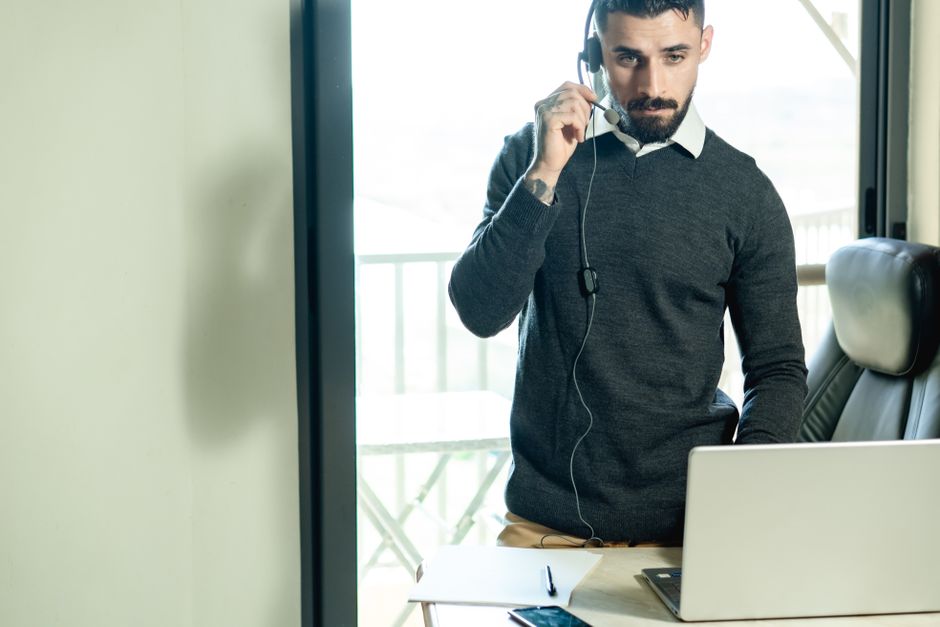 Remote Customer Support Jobs Paying In Usd Legitimate remote worker assisting a customer on laptop