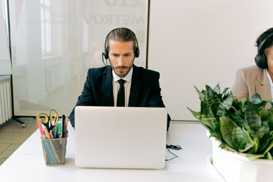 Remote Customer Support Jobs Paying In Usd Legitimate remote worker assisting a customer on laptop