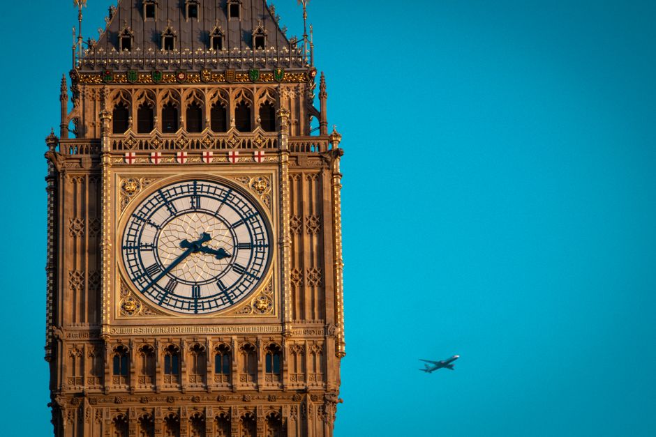 Best Cheap Flights To London From Lagos 2026: airplane flying over London skyline