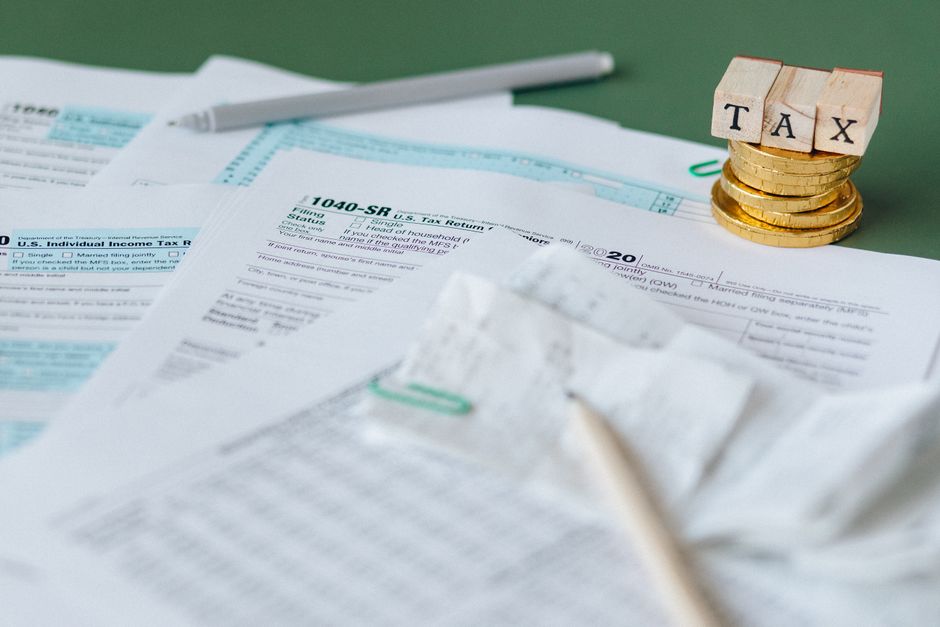 Crypto Tax Laws For Expats And Digital Nomads reviewing 2026 tax documents abroad