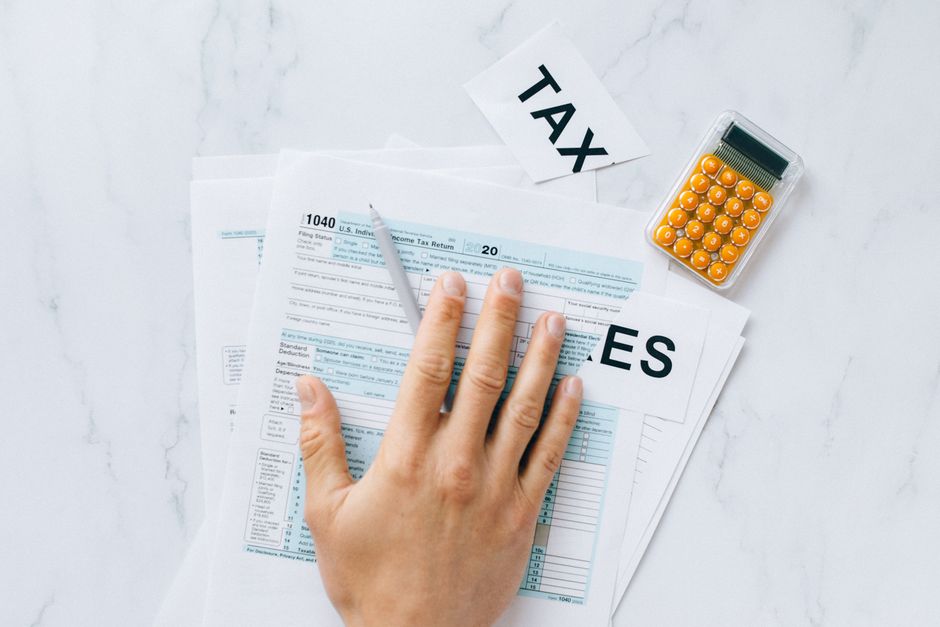Crypto Tax Laws For Expats And Digital Nomads reviewing 2026 tax documents abroad
